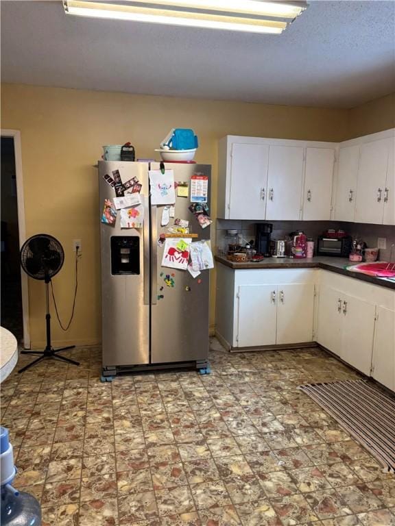 kitchen with sink, stainless steel fridge with ice dispenser, and white cabinets