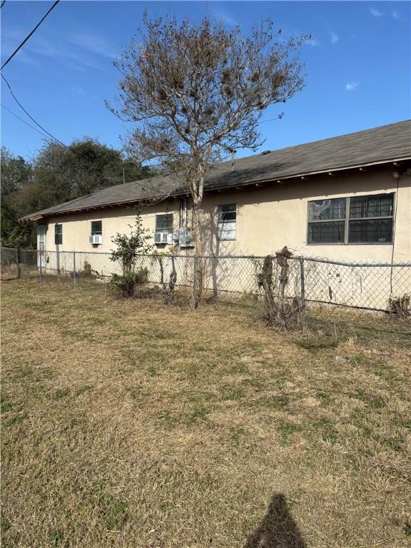 view of side of property featuring a yard