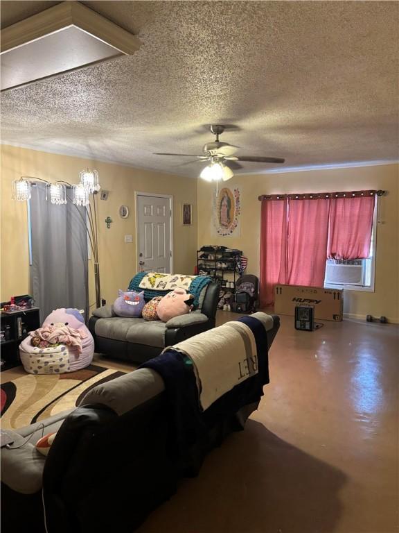 bedroom featuring cooling unit, a textured ceiling, and ceiling fan