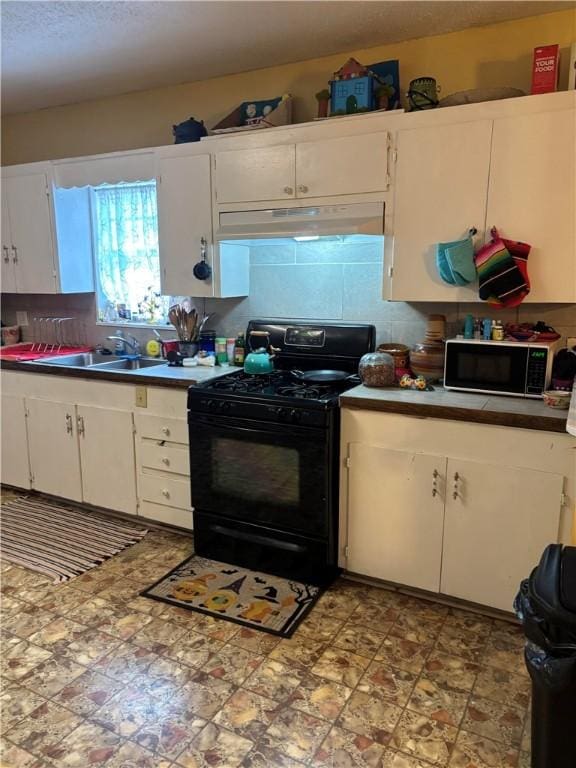 kitchen featuring decorative backsplash, sink, white cabinets, and black appliances