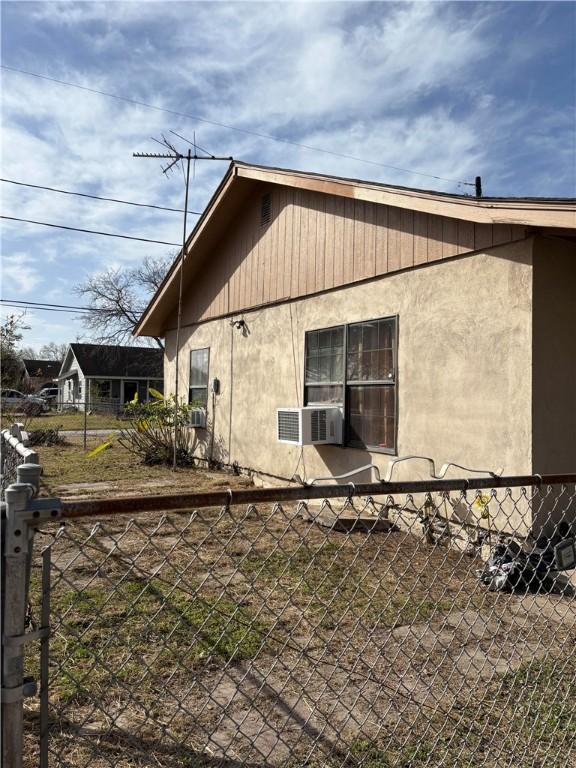 view of side of property with cooling unit