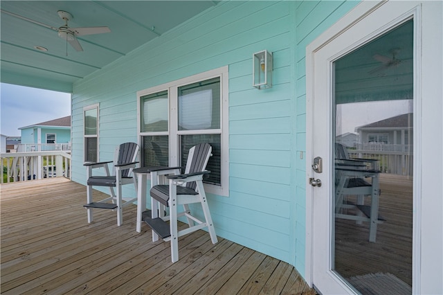 wooden deck featuring ceiling fan