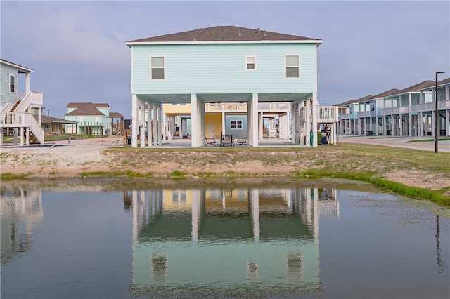 back of house with a water view