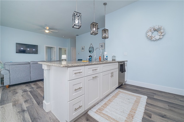 kitchen with white cabinets, hardwood / wood-style flooring, pendant lighting, and kitchen peninsula