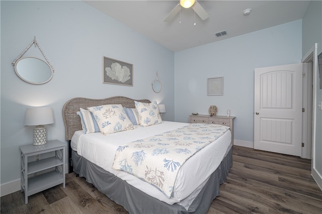 bedroom with ceiling fan and dark hardwood / wood-style floors