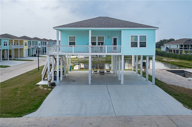 view of front of home with a water view and a carport