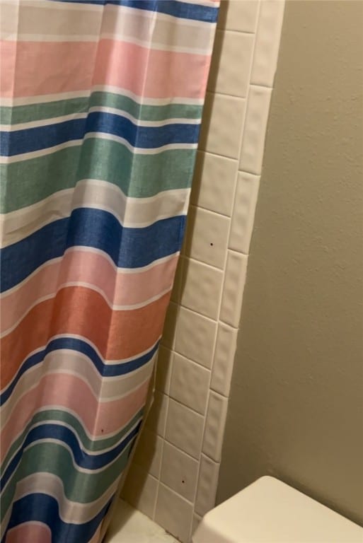 bathroom with a shower with curtain