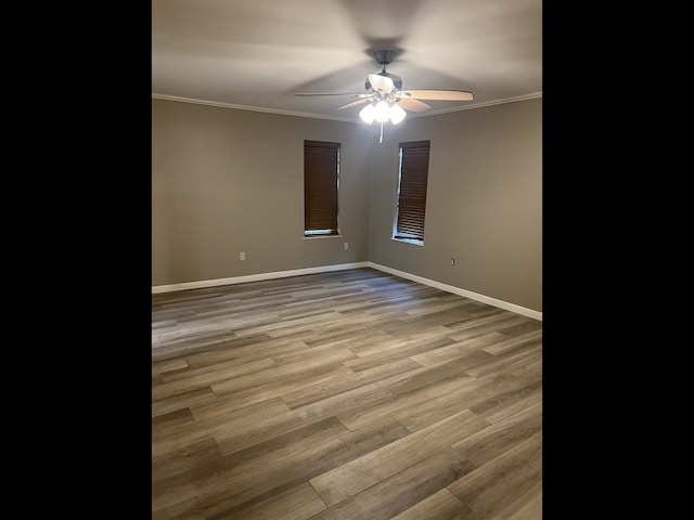 unfurnished room with hardwood / wood-style flooring, ceiling fan, and ornamental molding