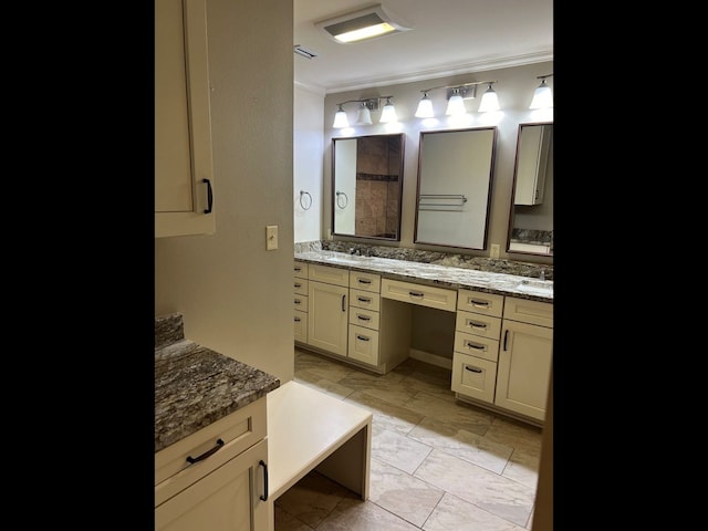 bathroom with vanity and ornamental molding