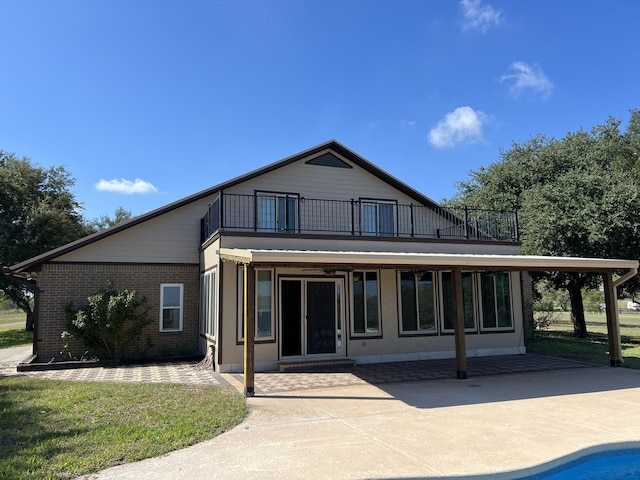 back of property with a patio and a balcony