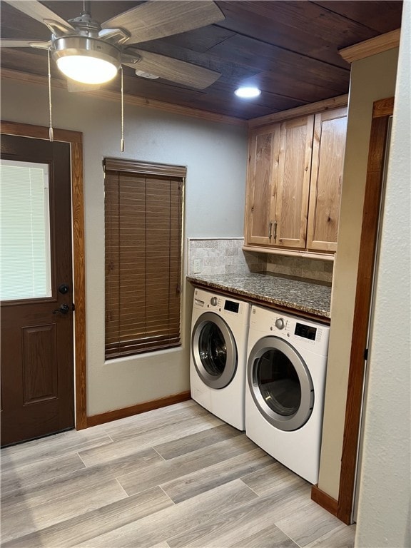 washroom with ceiling fan, cabinets, crown molding, light hardwood / wood-style floors, and washer and clothes dryer