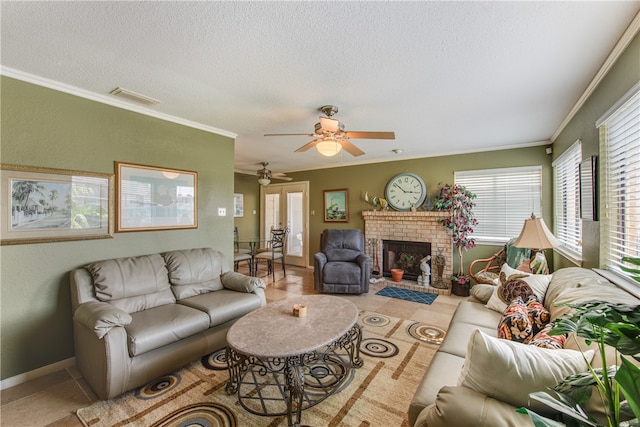 living room featuring a fireplace, a textured ceiling, tile patterned floors, and crown molding