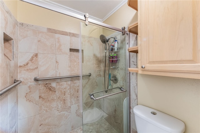 bathroom featuring toilet, ornamental molding, and a shower with door