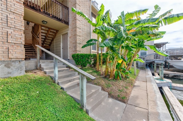 view of exterior entry featuring a balcony