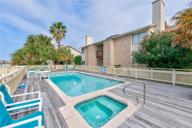 view of swimming pool with a wooden deck