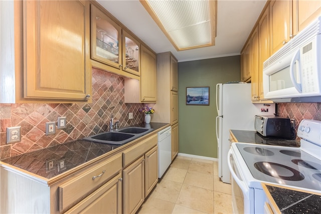 kitchen featuring light tile patterned flooring, white appliances, sink, and tasteful backsplash