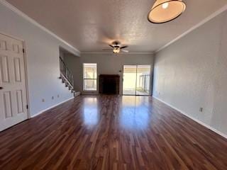 unfurnished living room with crown molding, baseboards, and wood finished floors
