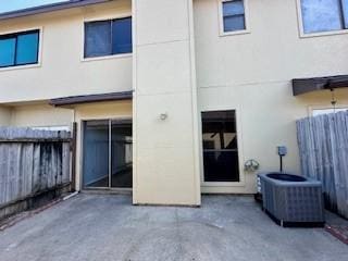 back of house with stucco siding, a patio area, and fence