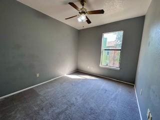 carpeted spare room with baseboards and ceiling fan