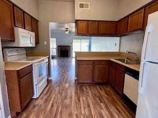kitchen with ceiling fan, visible vents, light countertops, light wood-style floors, and white appliances