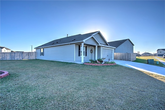 ranch-style home featuring a garage and a front lawn