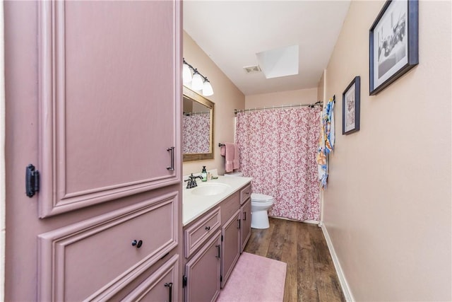 6309 Brianna Cir, Corpus Christi, TX 78414 - bathroom featuring vanity, wood finished floors, a skylight, and a shower with curtain