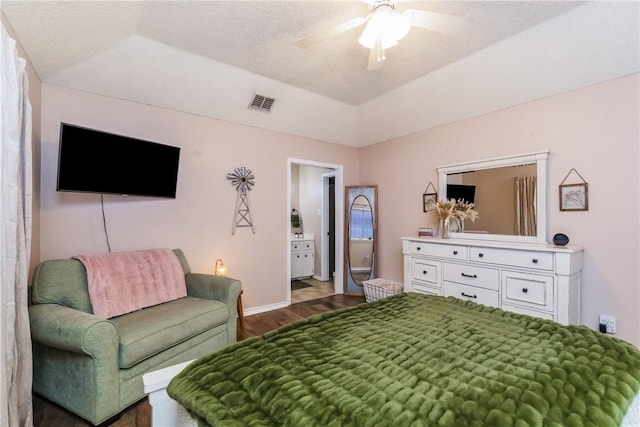 6309 Brianna Cir, Corpus Christi, TX 78414 - bedroom with dark wood-style flooring, a ceiling fan, and connected bathroom