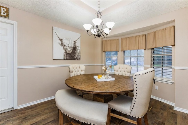 6309 Brianna Cir, Corpus Christi, TX 78414 - dining room featuring dark wood-type flooring, a chandelier, and a textured ceiling