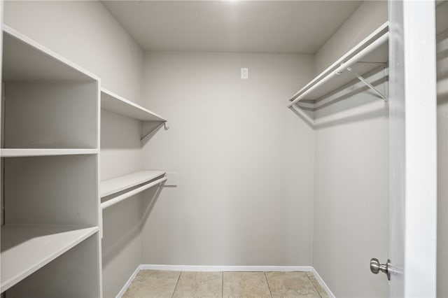 walk in closet featuring light tile patterned floors