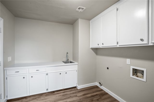 laundry room with cabinets, hookup for a washing machine, hookup for an electric dryer, sink, and dark hardwood / wood-style floors