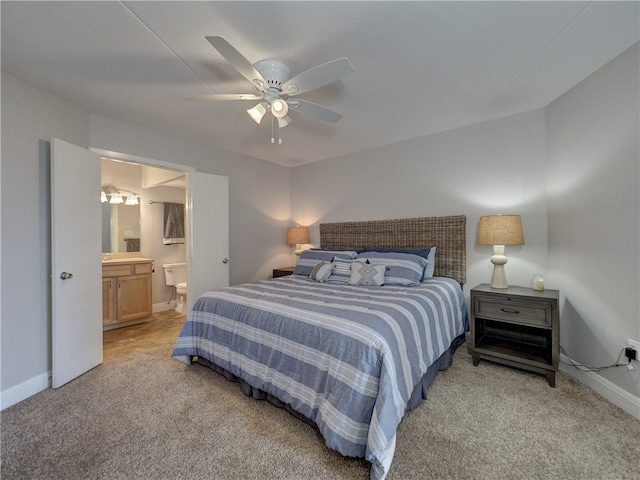 carpeted bedroom with ceiling fan and ensuite bathroom