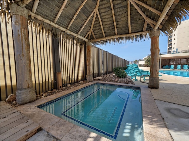 view of swimming pool with a patio and a gazebo