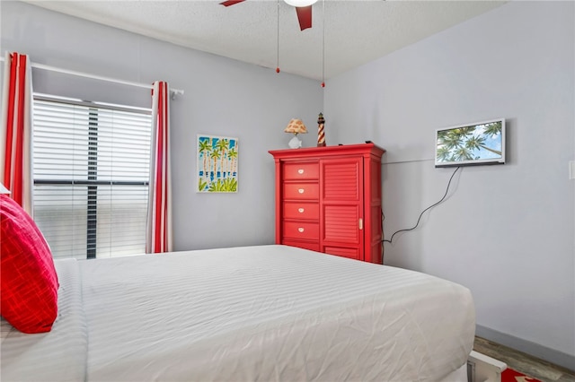 bedroom featuring ceiling fan and a textured ceiling