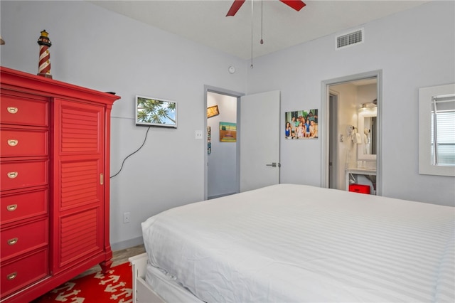 bedroom with ensuite bath and ceiling fan