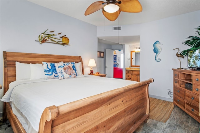 bedroom featuring ceiling fan, dark hardwood / wood-style floors, and ensuite bath