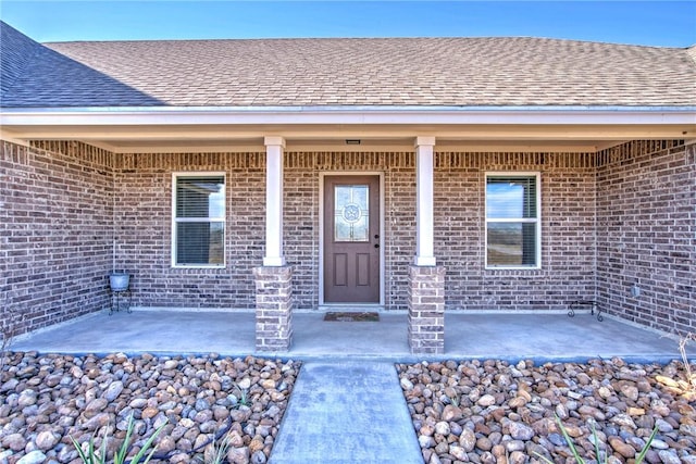 view of exterior entry with a patio area