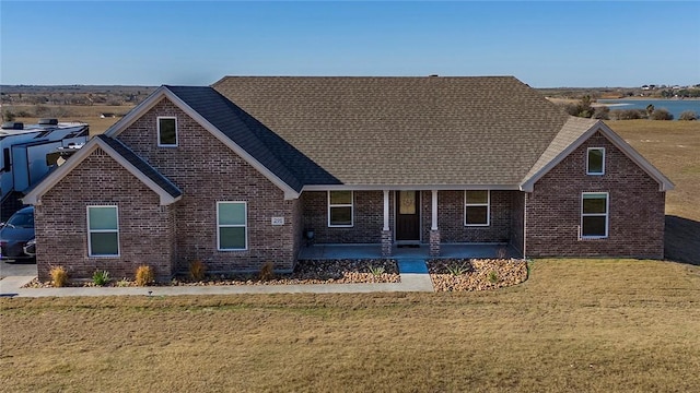 view of front of home with a patio and a front lawn