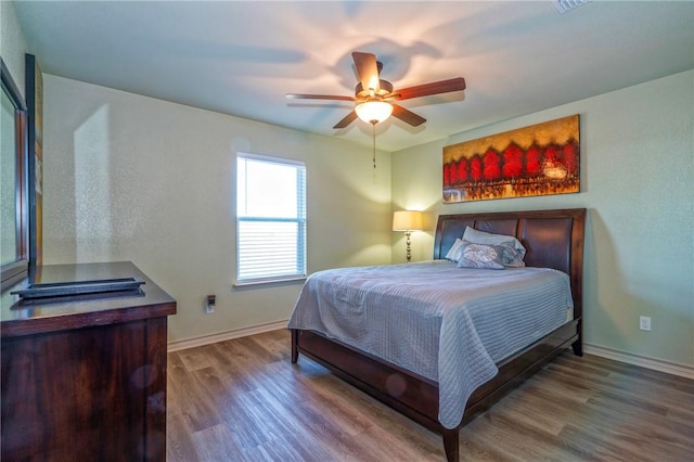 bedroom with hardwood / wood-style floors and ceiling fan