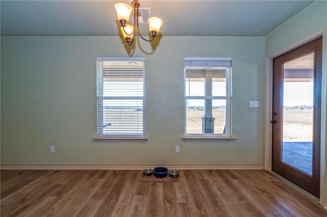 interior space featuring a notable chandelier and hardwood / wood-style floors