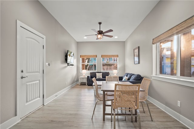 dining space with ceiling fan and light wood-type flooring