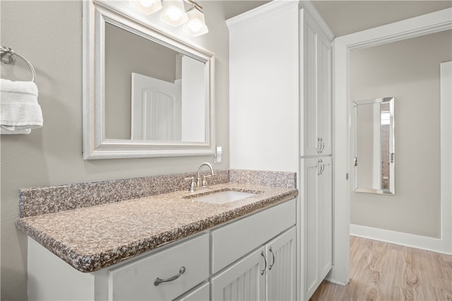 bathroom featuring wood-type flooring and vanity