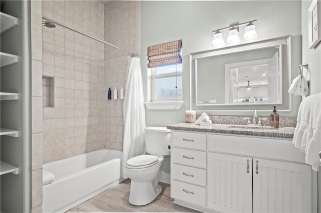 full bathroom with ceiling fan, wood-type flooring, toilet, shower / bath combo with shower curtain, and vanity