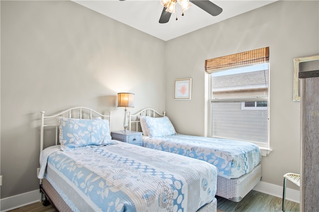 bedroom featuring ceiling fan and dark wood-type flooring