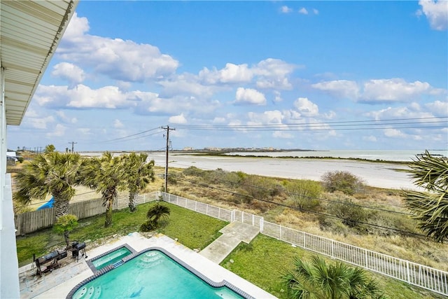 view of pool with an in ground hot tub, a water view, a yard, and a patio