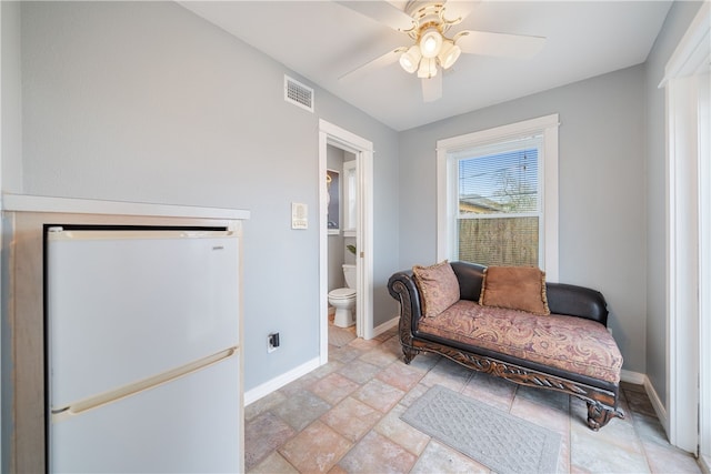 living area with ceiling fan