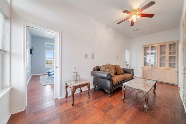 living room with wood-type flooring and ceiling fan