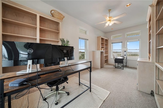 carpeted home office featuring ceiling fan and a wealth of natural light