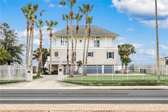 view of front of home with a balcony and a front yard