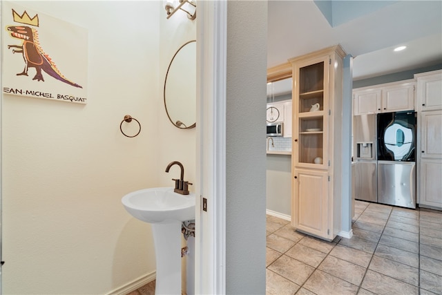 bathroom with tile patterned flooring and sink