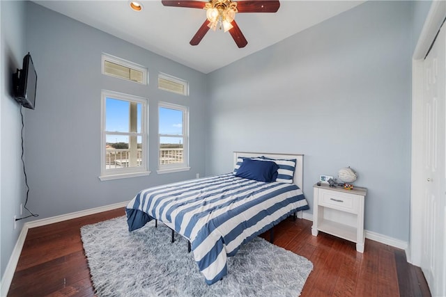 bedroom with dark hardwood / wood-style floors and ceiling fan